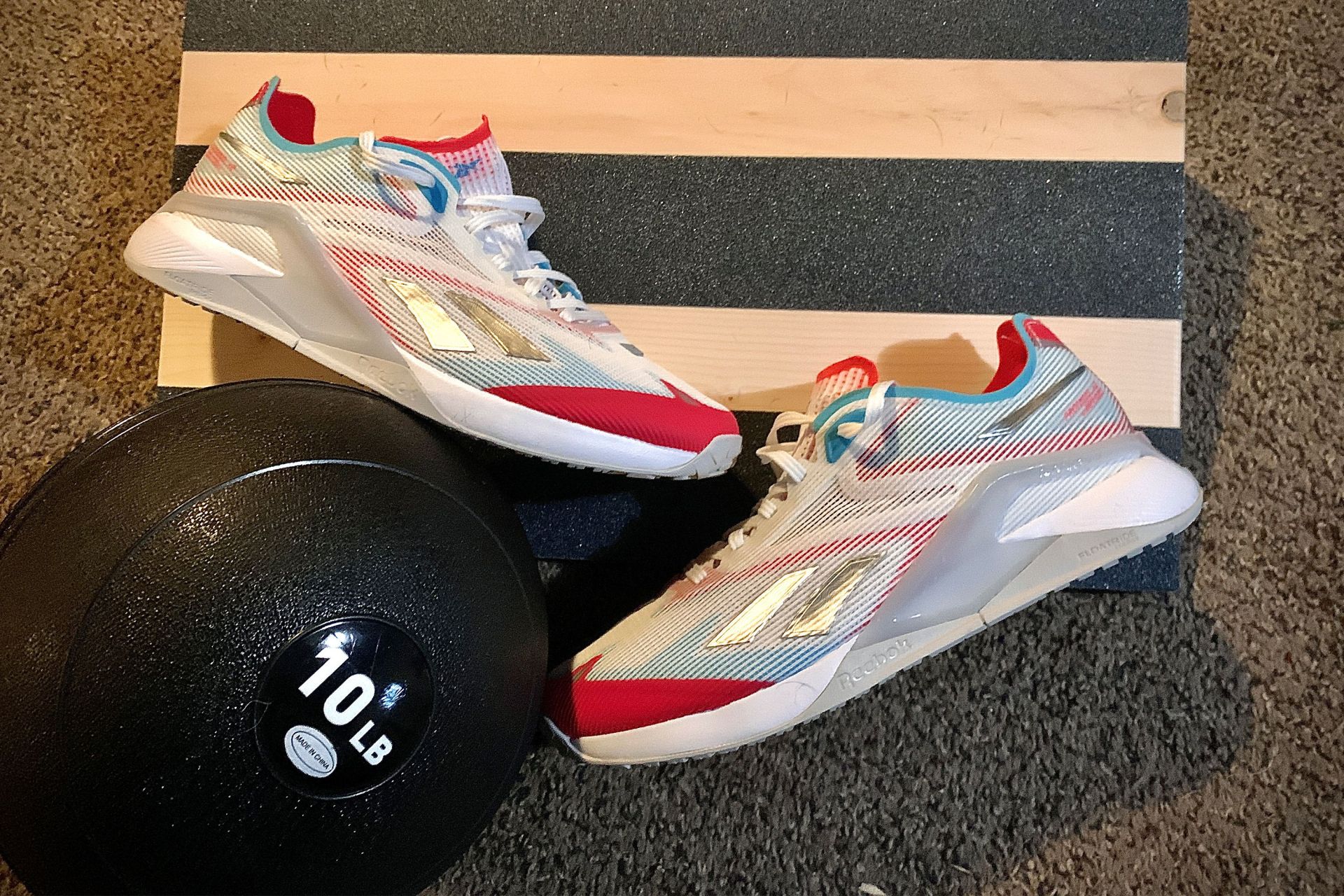 reebok nano x2 froning shoes next to a weight ball
