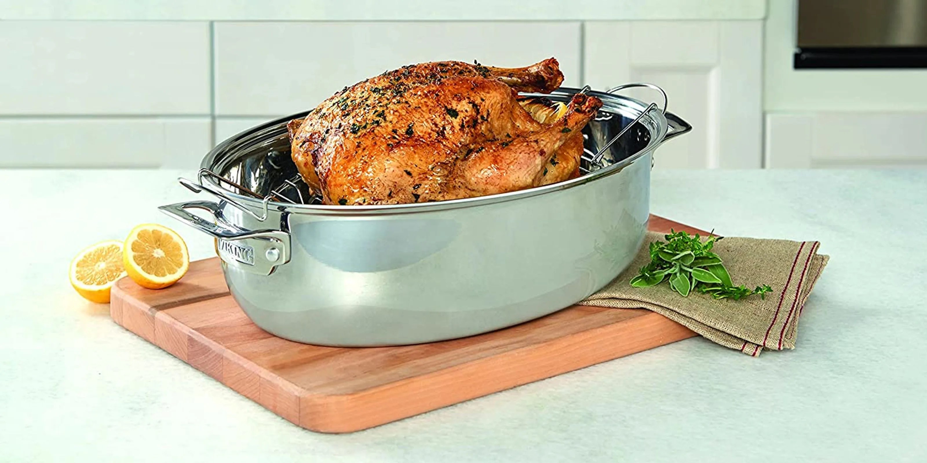 a roasted turkey sitting in a pan on a counter