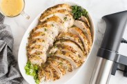 a plate of cooked turkey next to a sou vide machine