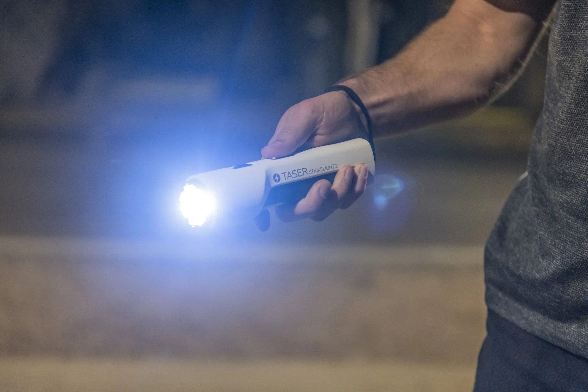 man holding taser strikelight 2 stun gun flash light