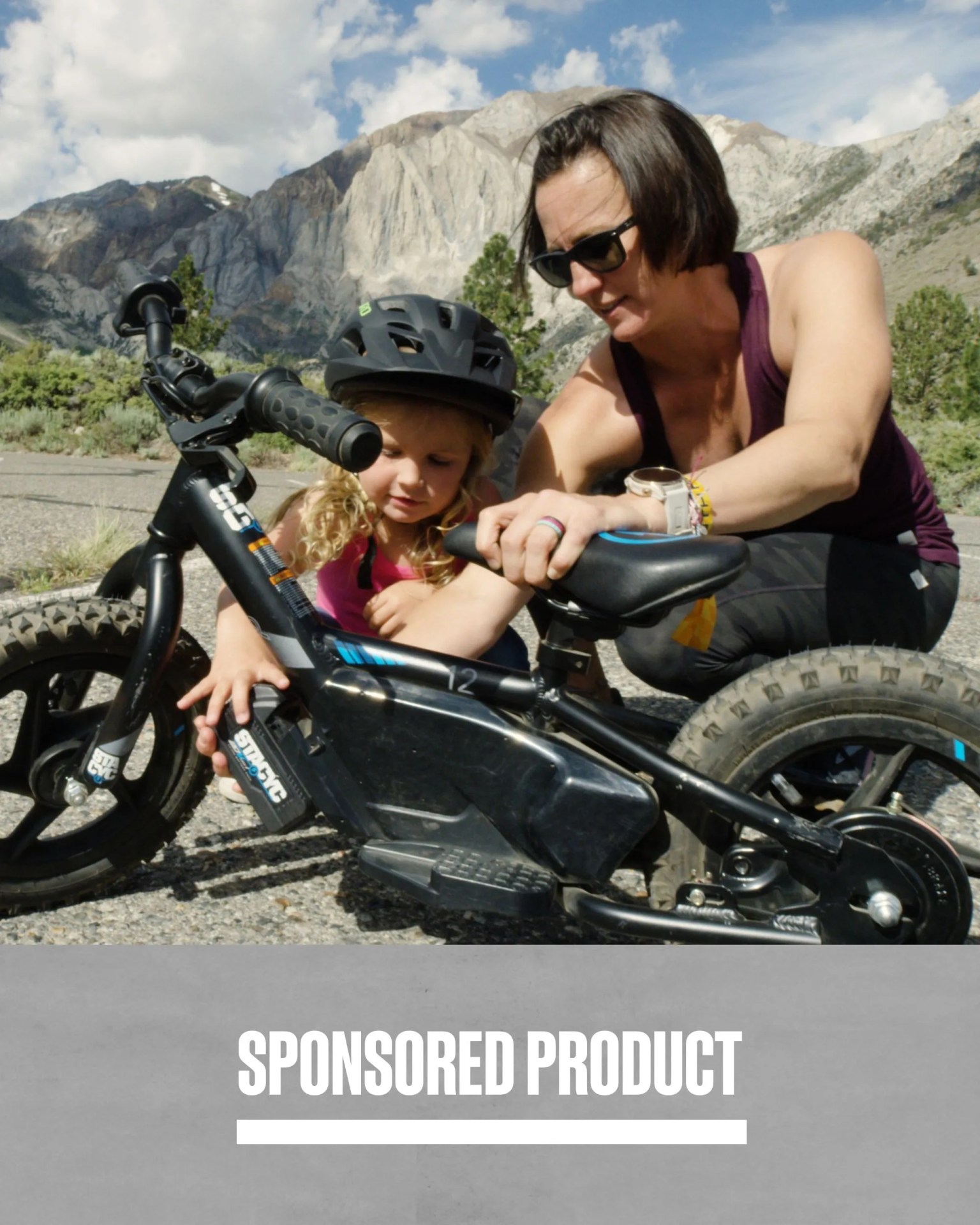sponsored product mom helping daughter set up stacyc 12edrive bike