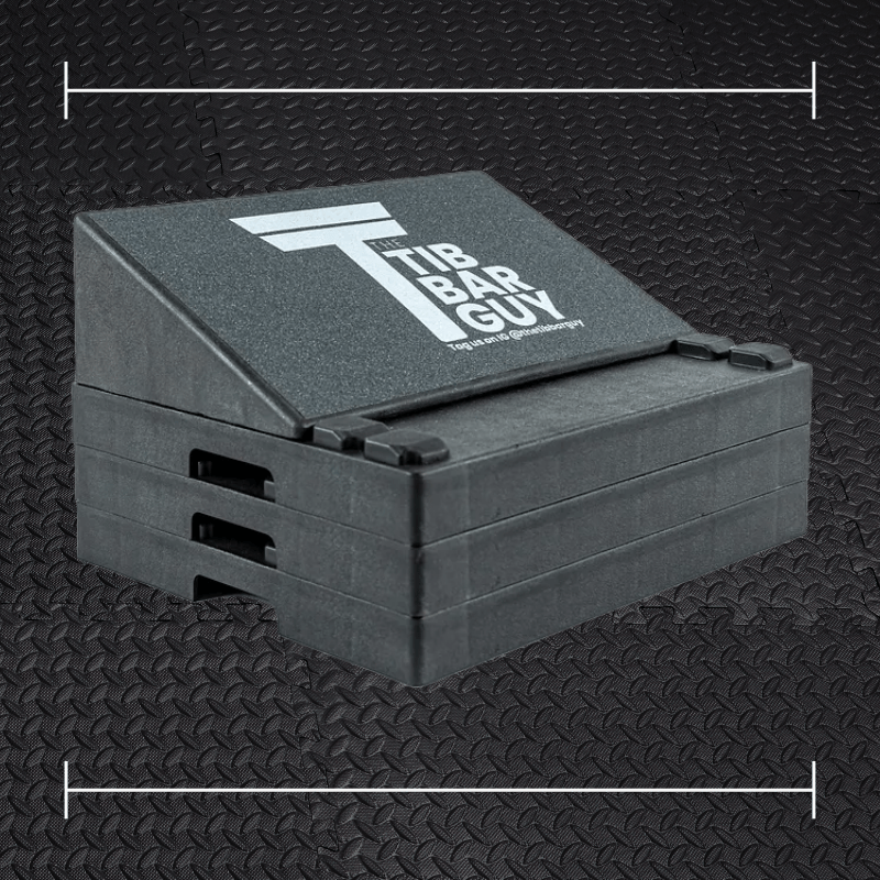 a black slanted stack laid over top a photo of black rubber gym flooring