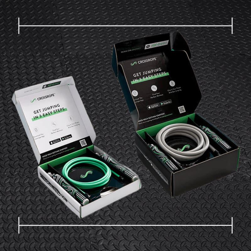 2 boxes of crossrope gear laid overtop a photo of black rubber gym flooring