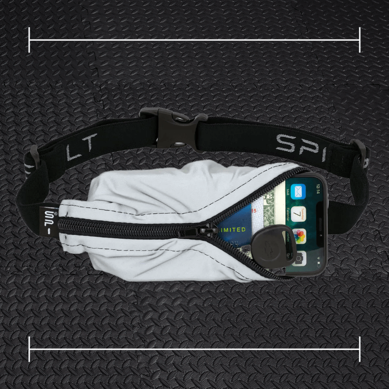 a reflective spibelt running belt laid over top a photo of black rubber gym flooring