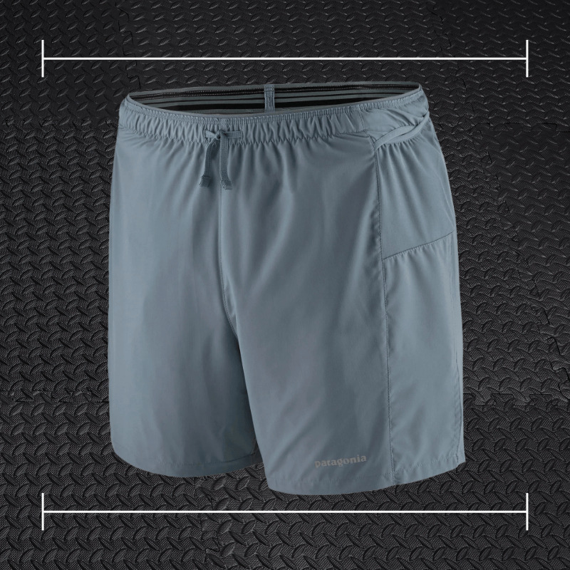grey patagonia shorts laid over top a photo of black rubber gym flooring