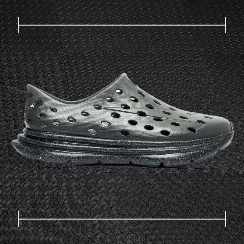black kane recovery shoes laid over top a photo of black rubber gym flooring