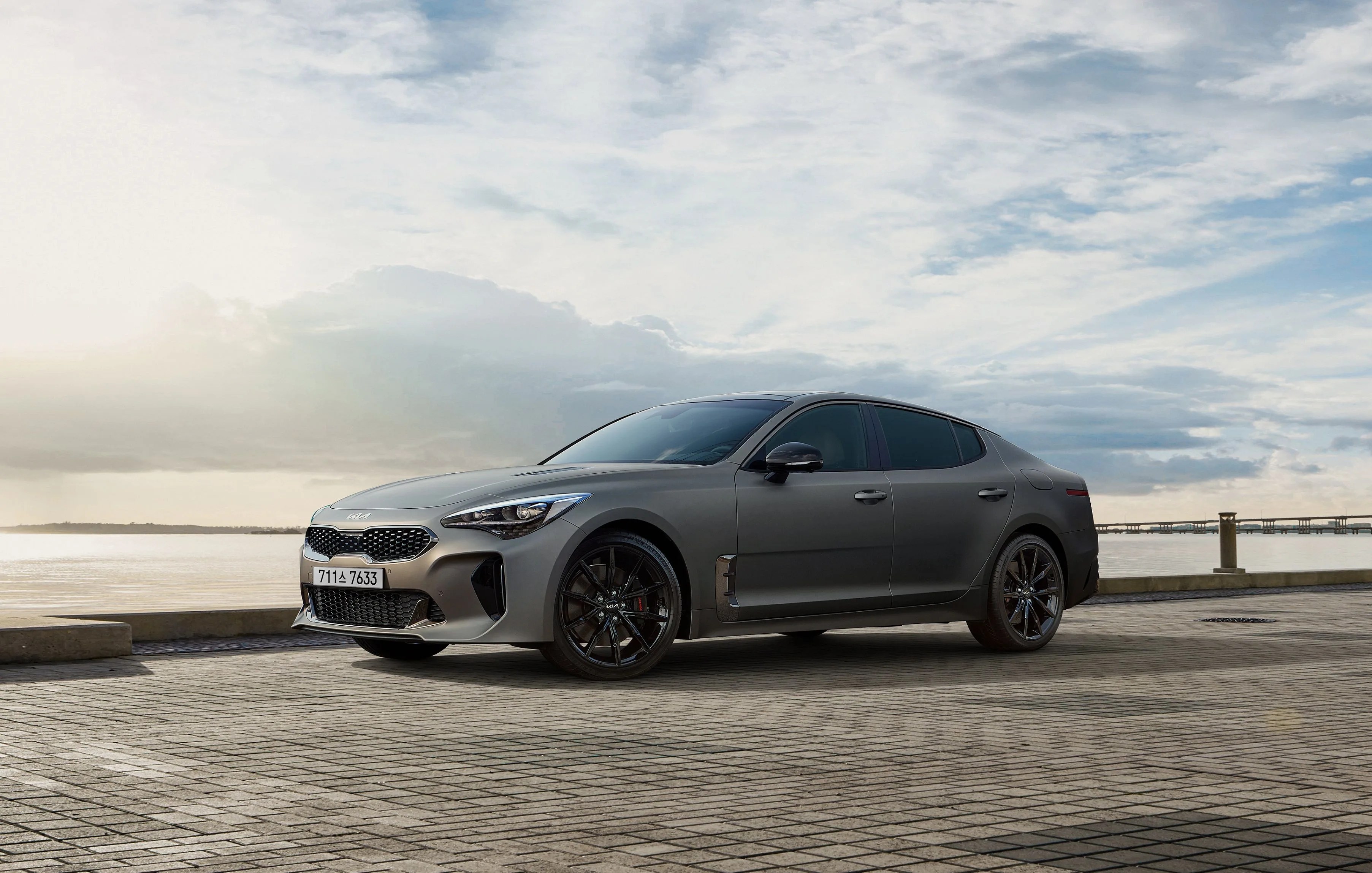 kia stinger tribute edition parked next to the water in california