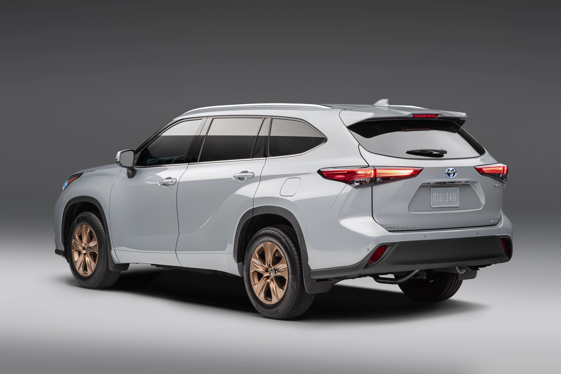 toyota highlander hybrid rear quarter shot in a blank studio