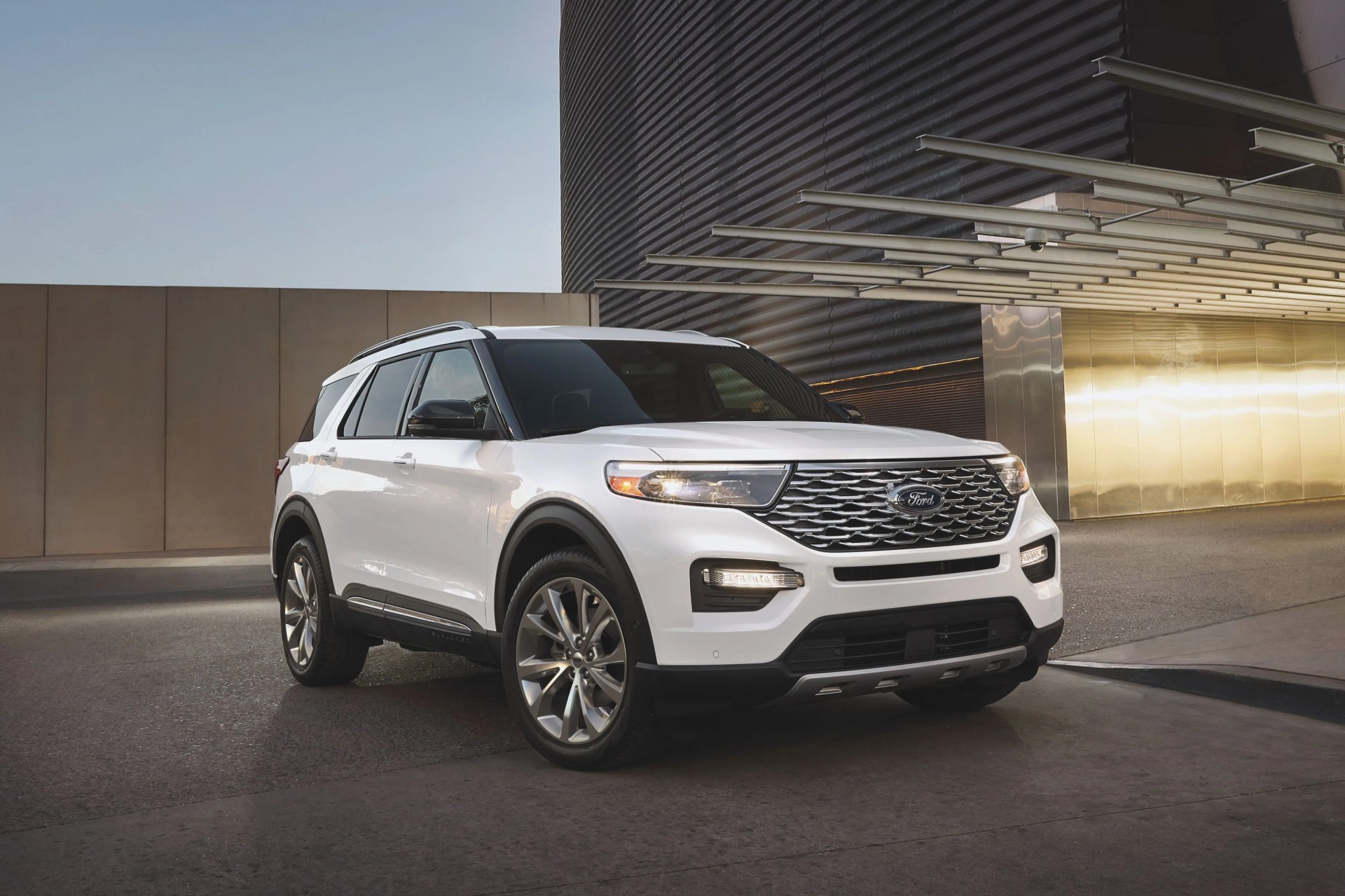ford explorer hybrid in front of a modern parking garage