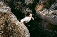 woman hiking through rocks