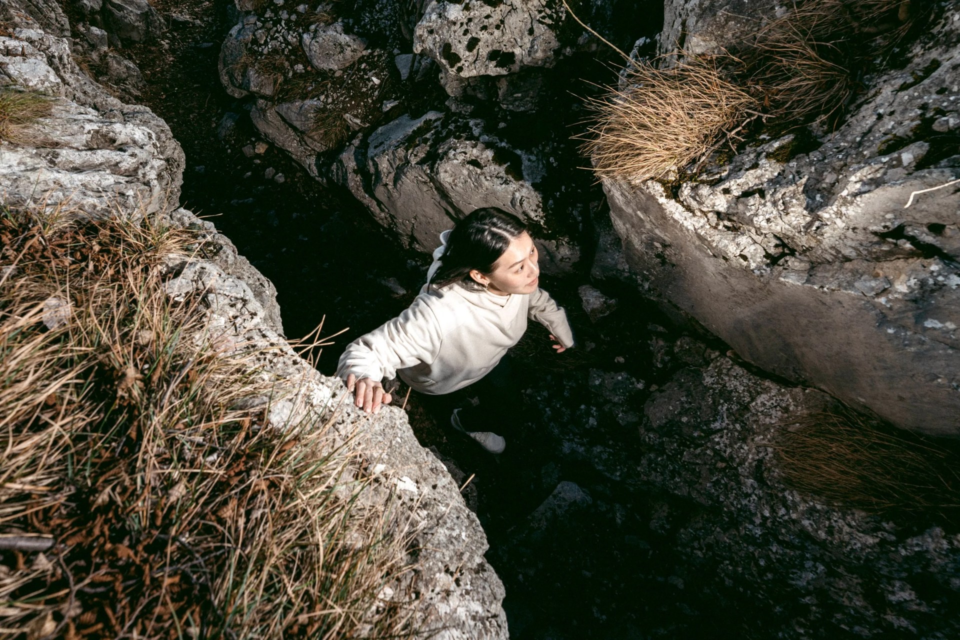 woman hiking through rocks