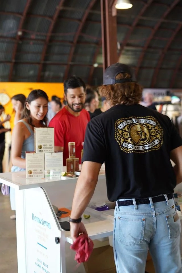 american field man working for epic western cocktail company showing customers their products