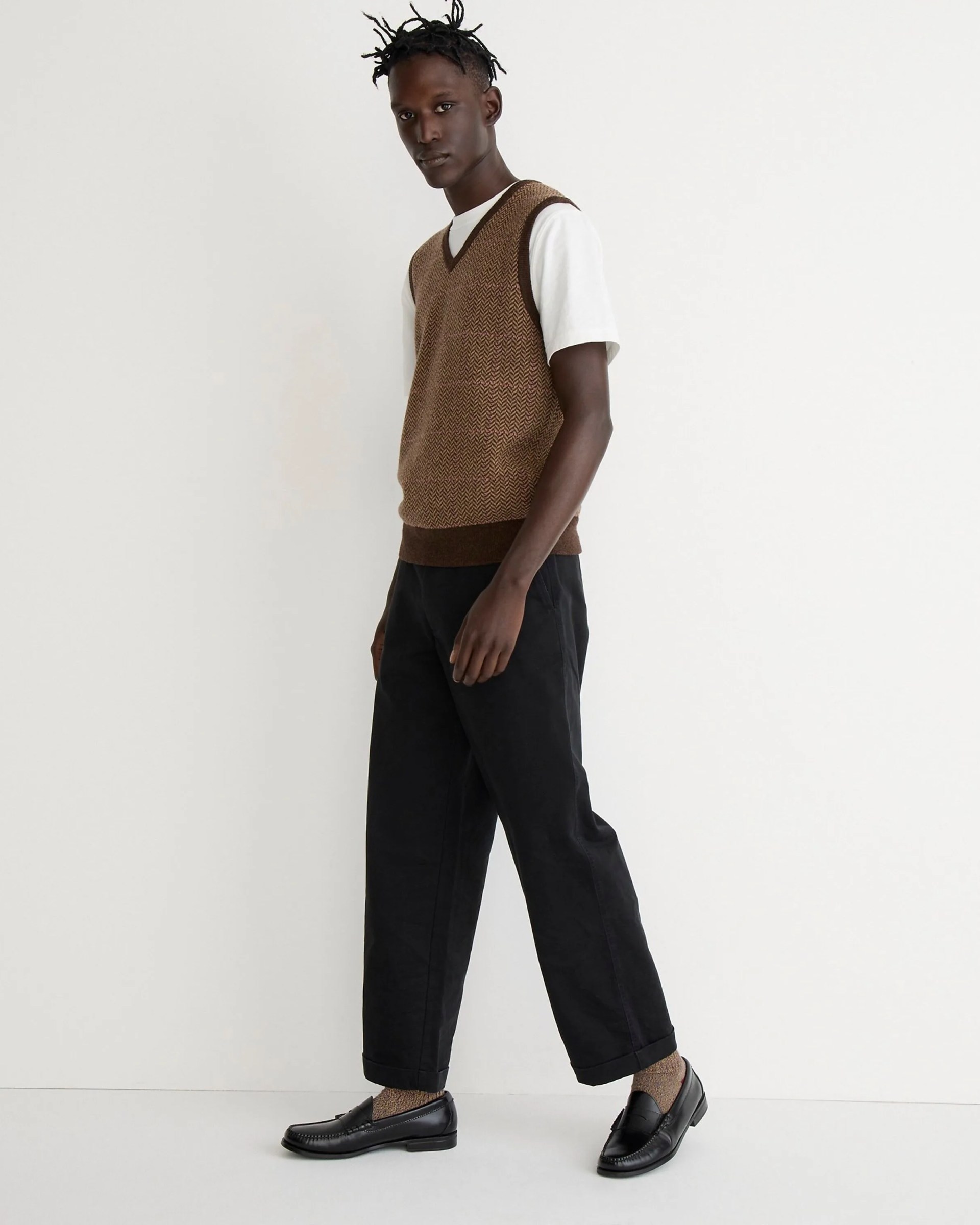 man wearing black chinos and a vest