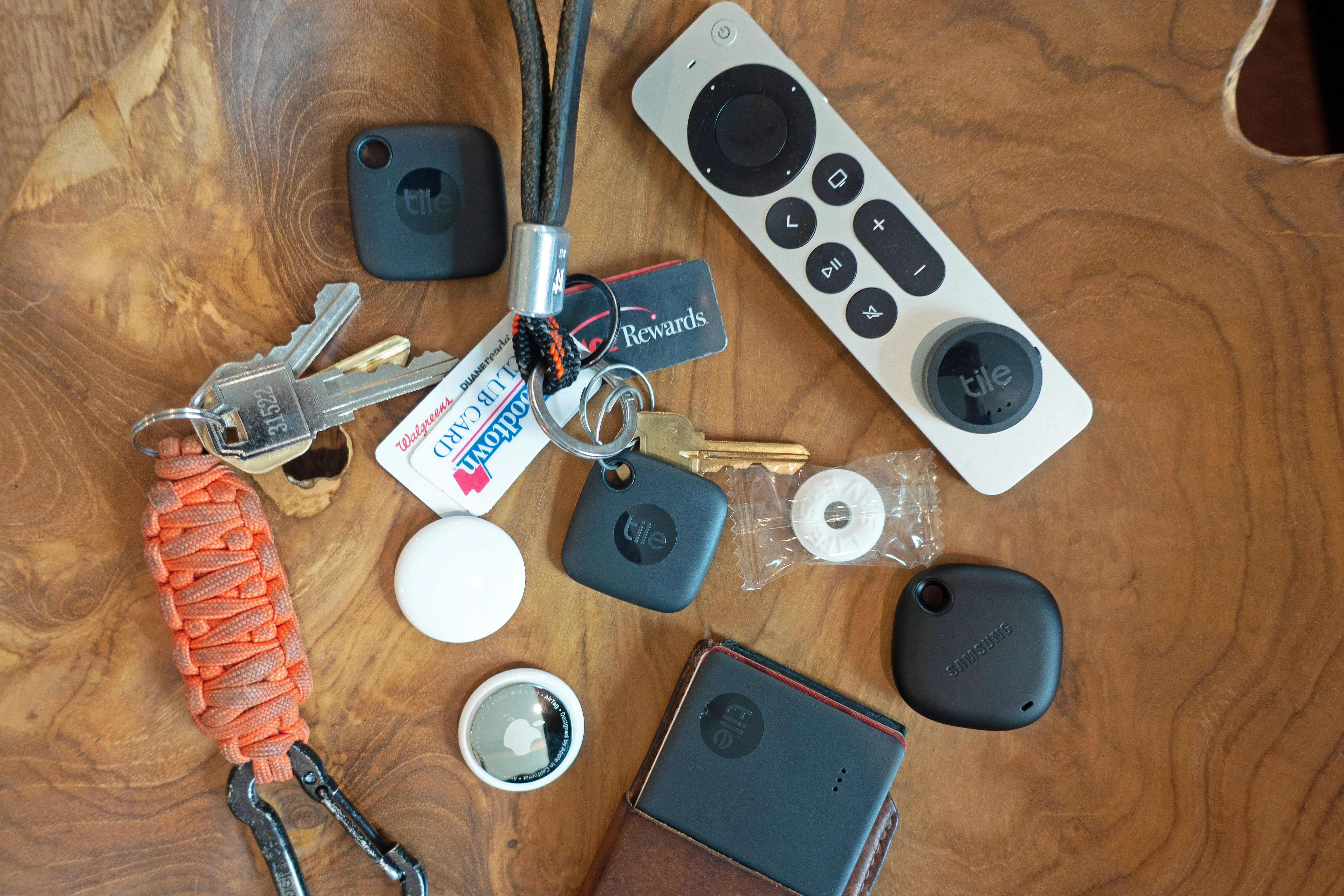 bluetooth trackers on a table with remote and keys