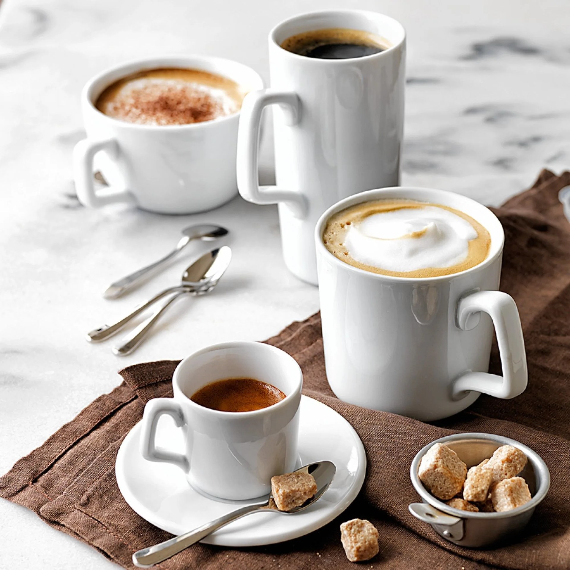 a variety of coffee drinks on a counter