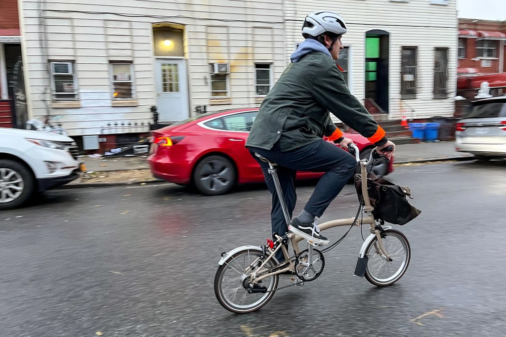 a man riding a bike in a city