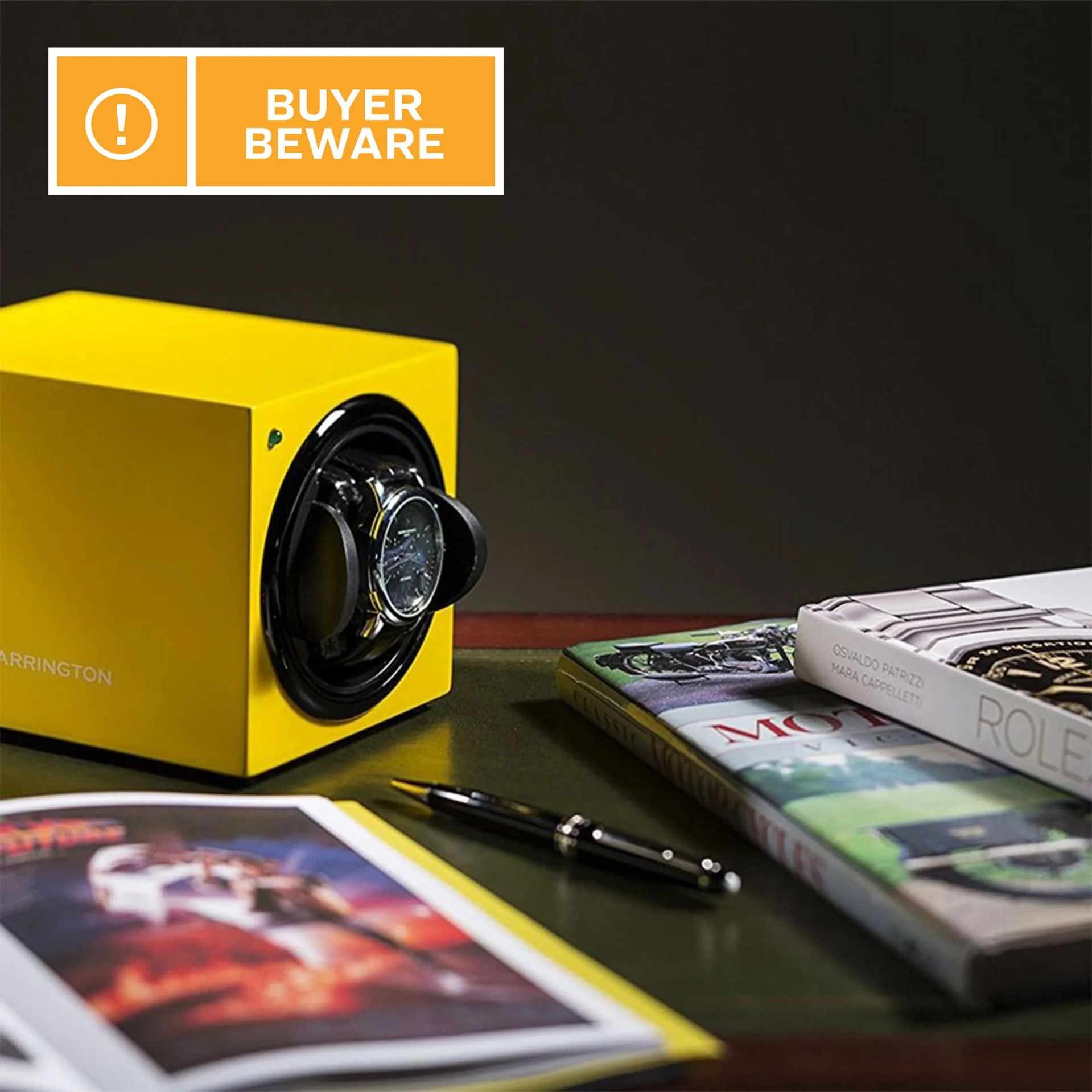 books, magazines, and a watch winder on a table