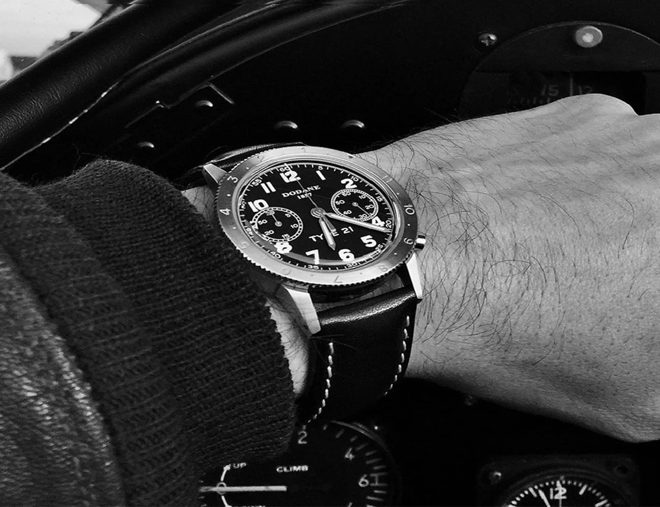 man wearing a dodane watch while driving