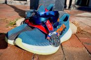 engo 2 sunglasses sitting on hoka shoes with a running metal