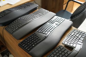 four ergonomic keyboards on a table