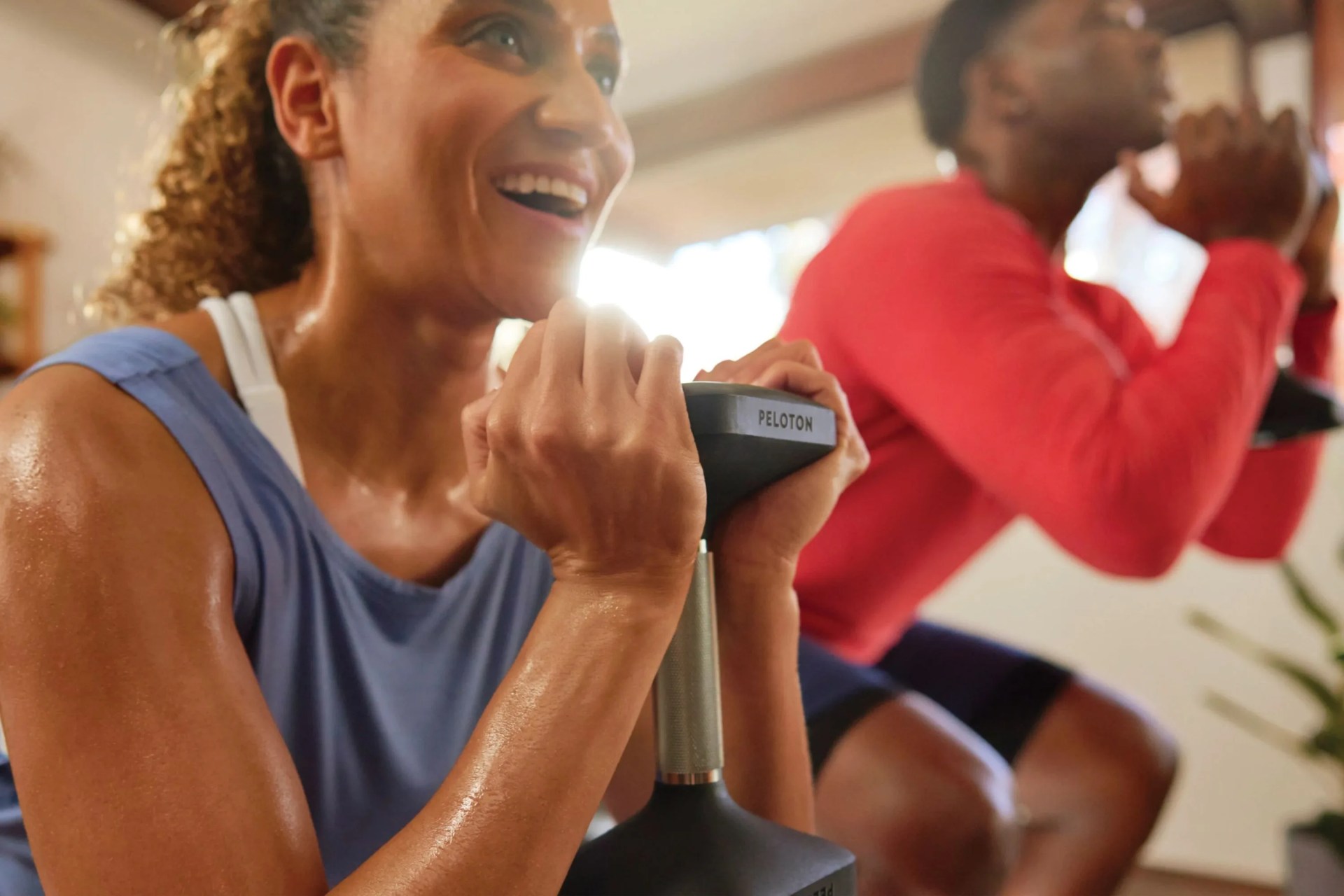 man and woman working out at home peloton fitness app