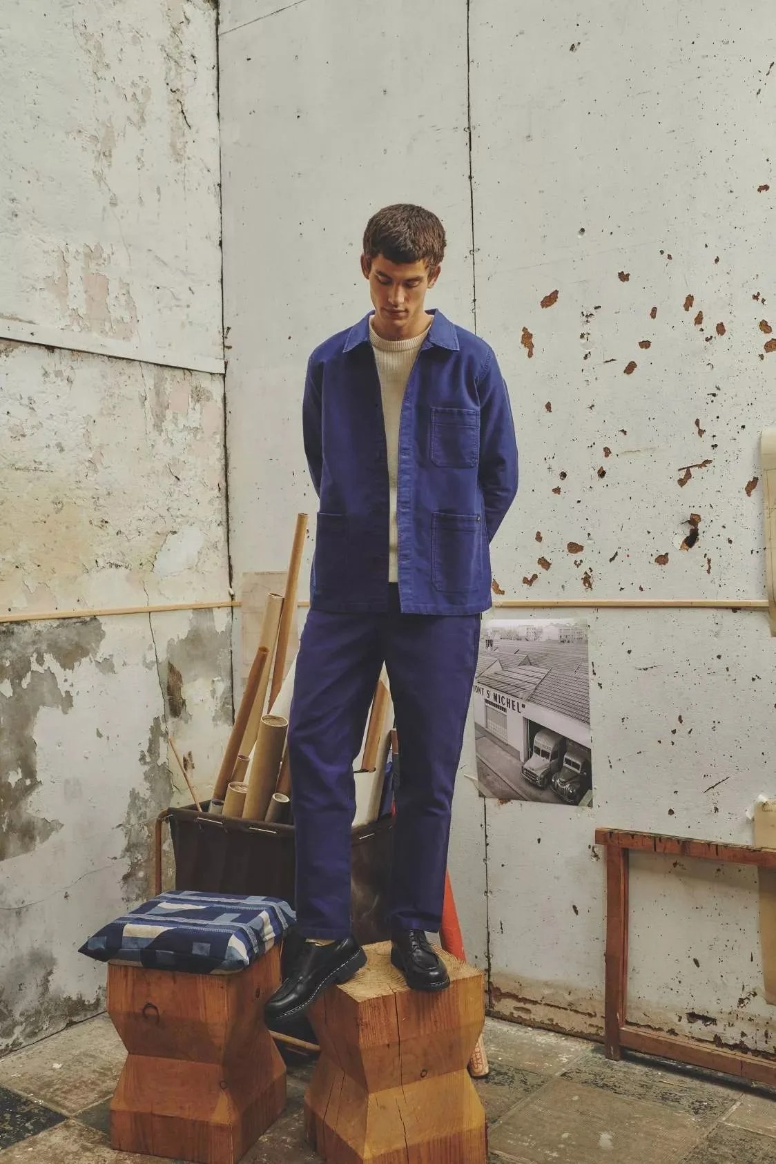 a man wearing a blue chore coat