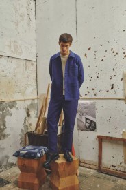 a man wearing a blue chore coat