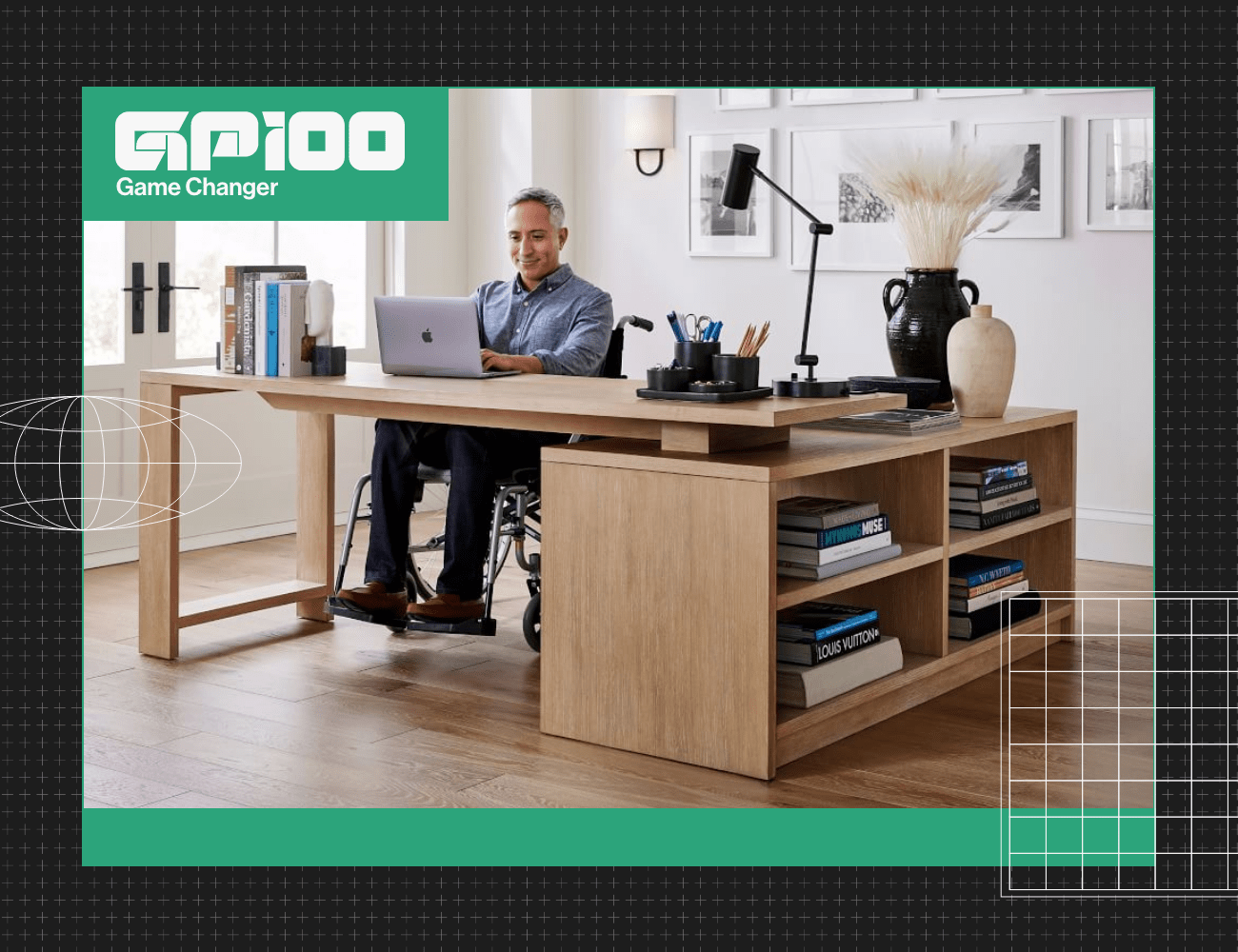 a man in a wheel chair working at a desk
