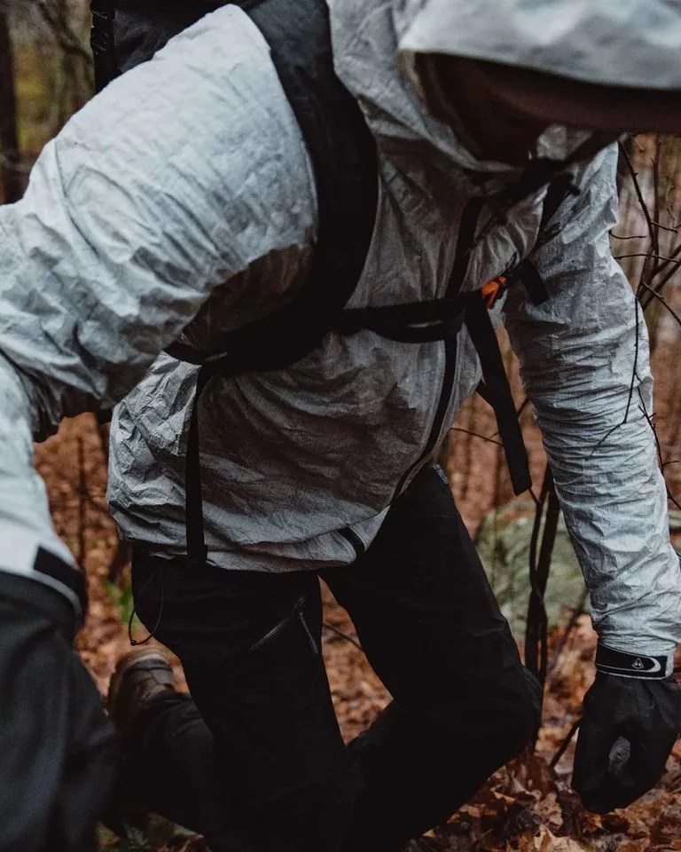 person hiking wearing hyperlite mountain gear the shell jacket