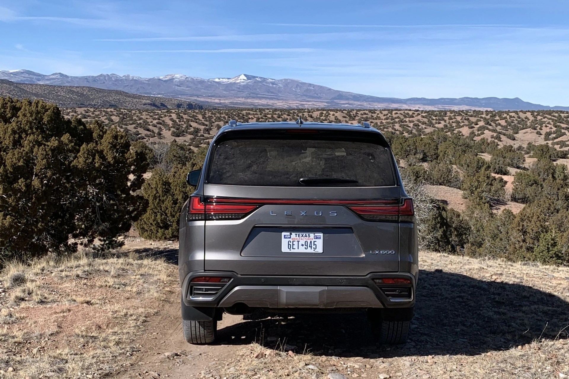 lexus lx 600 from the rear overlooking a mountain landscape