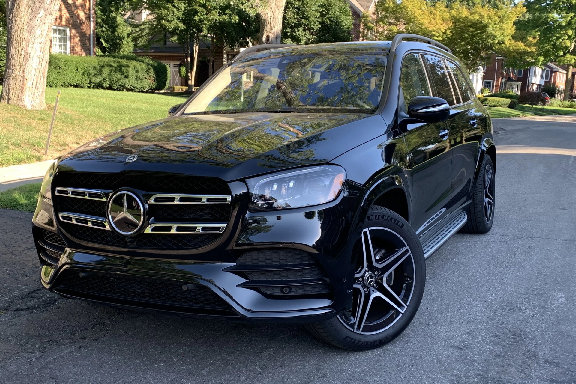 mercedes suv parked on side of suburban street