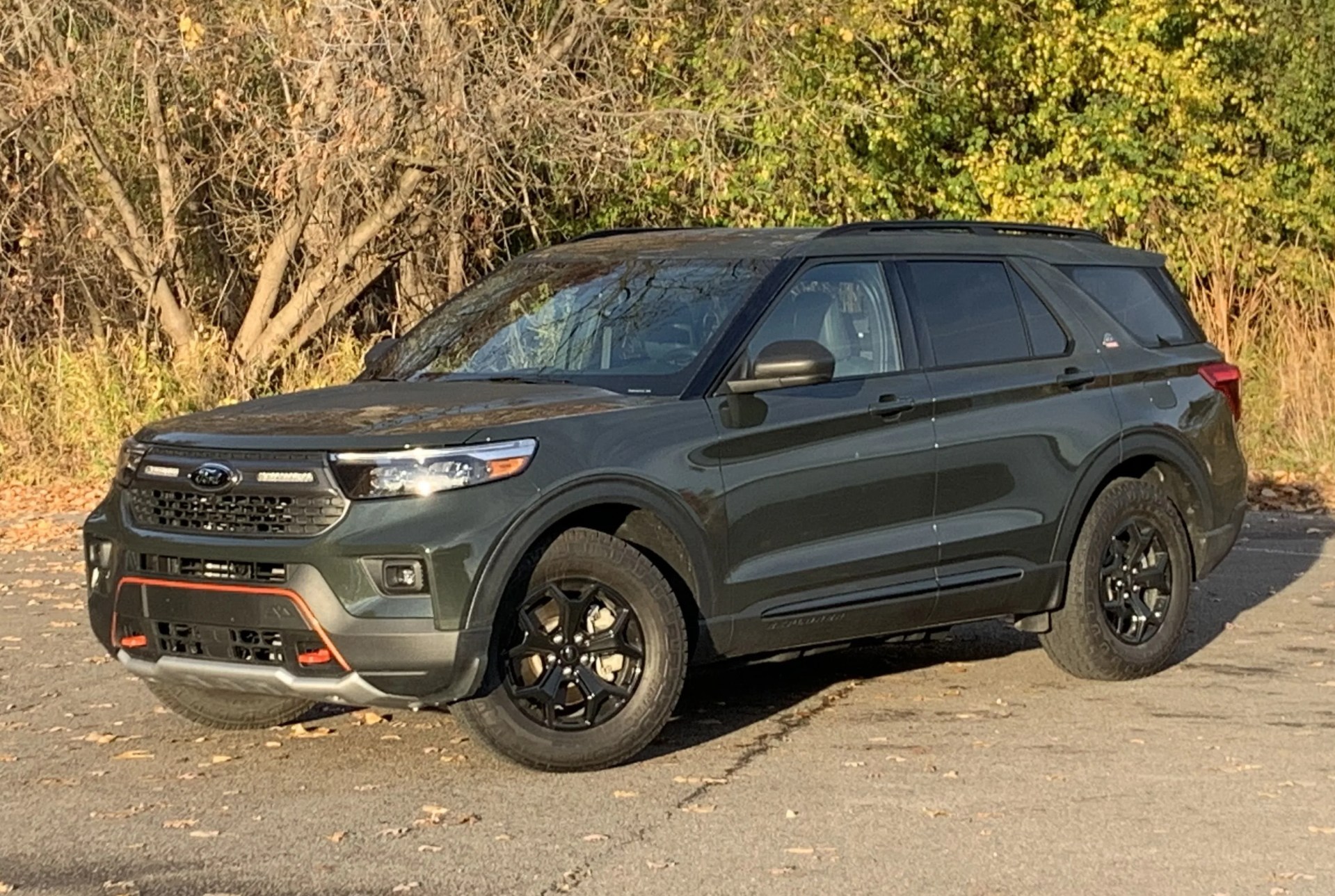 ford explorer timberline parked in front of woods