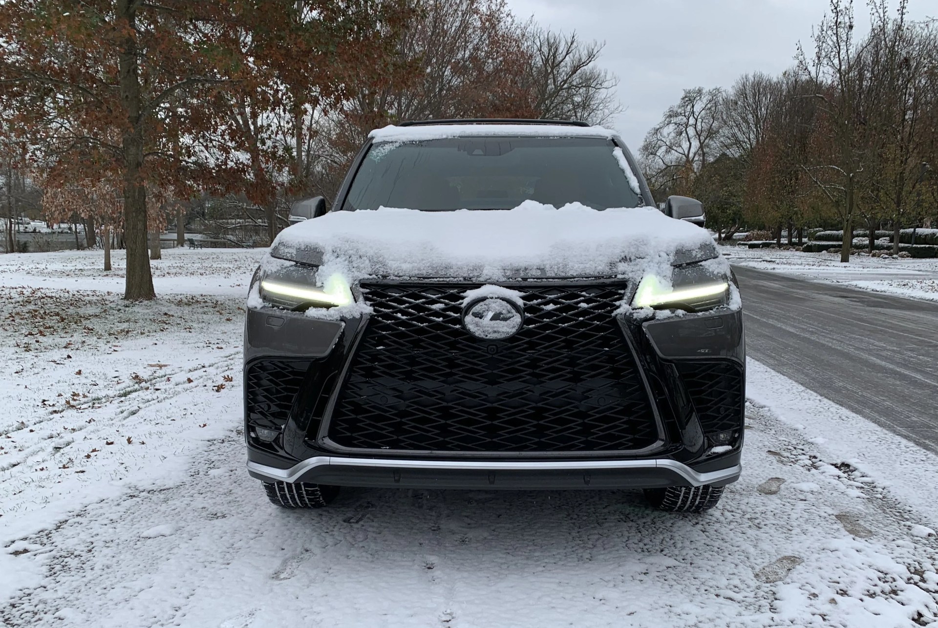 lexus lx 600 parked alongside snowy road