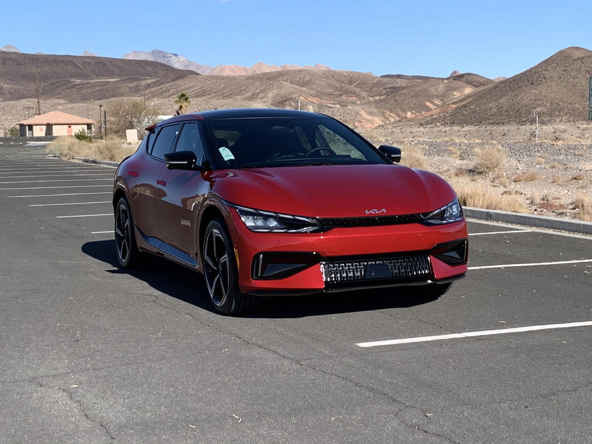 kia ev6 in a parking lot with desert in the background