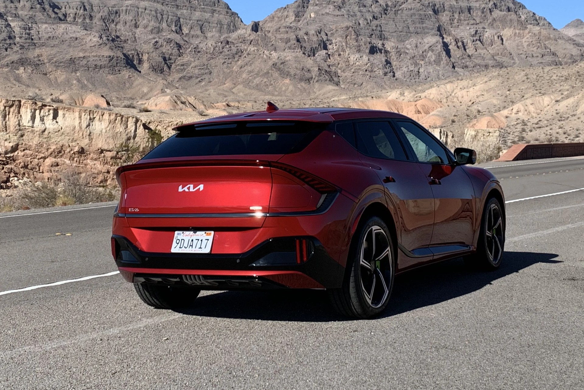 kia ev6 parked with mountains in the background