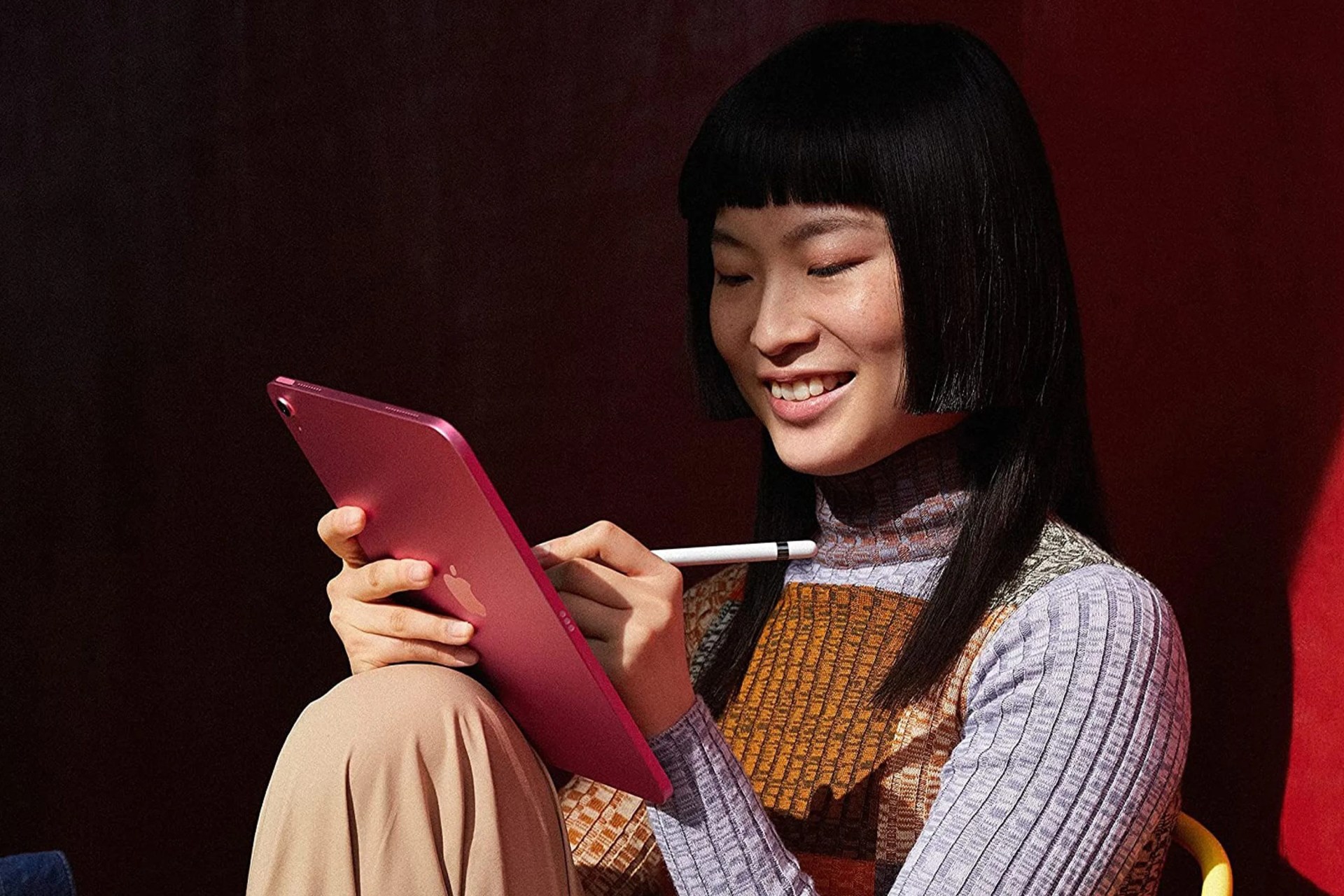 a woman writing on an ipad