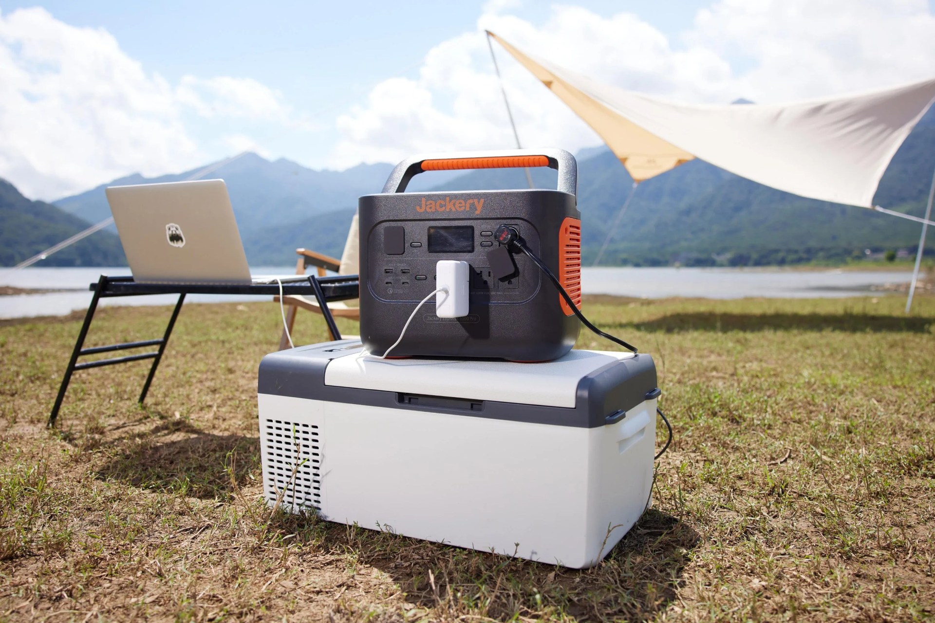the jackery solar generator 1000 pro placed at a camp setup in front of a mountain view