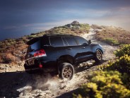 toyota land cruiser driving on a desert trail
