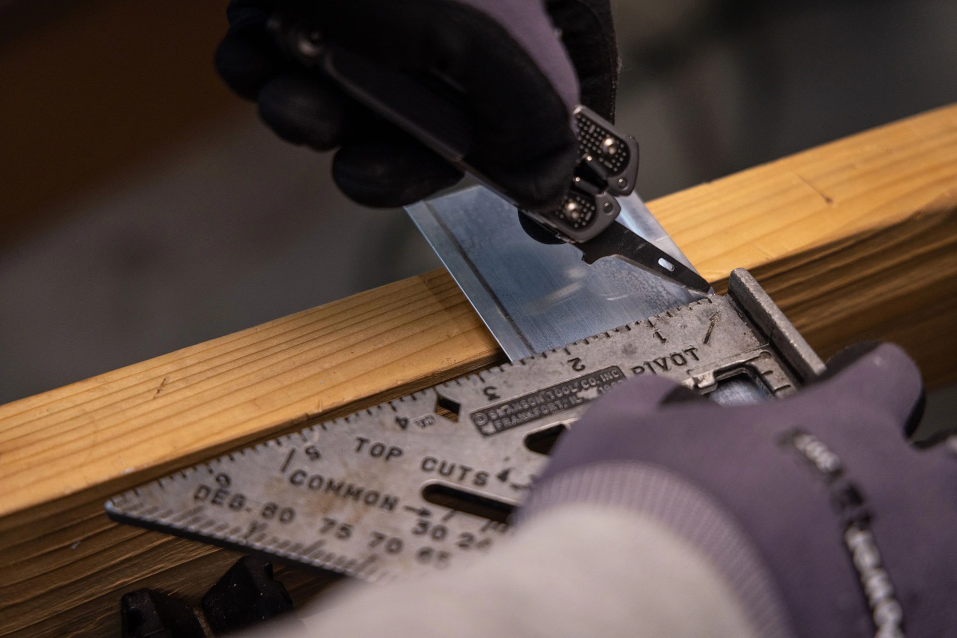 person using leatherman tool to cut