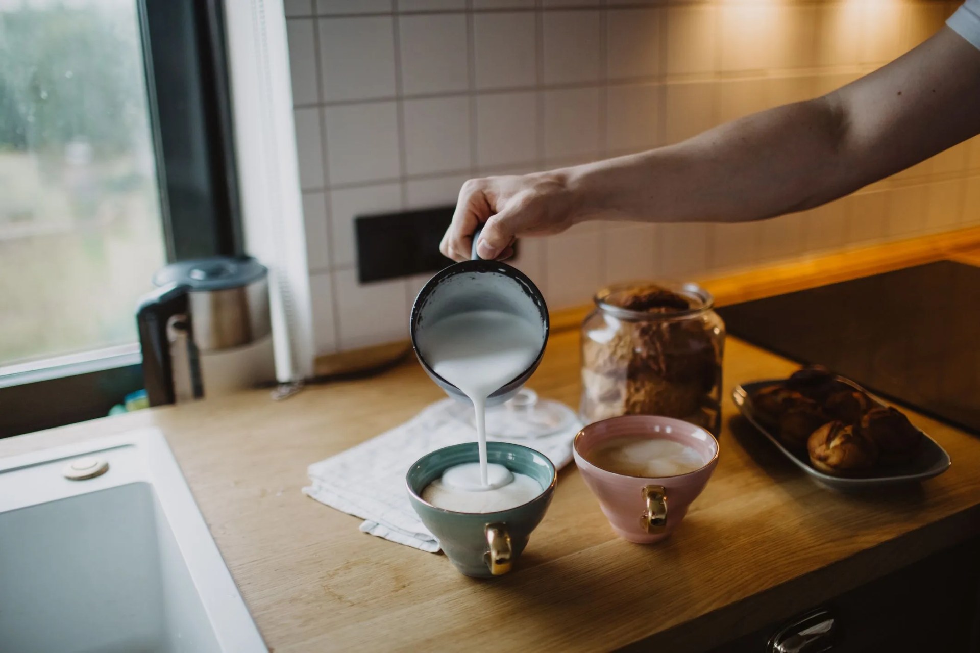 man's hand makes coffee at home