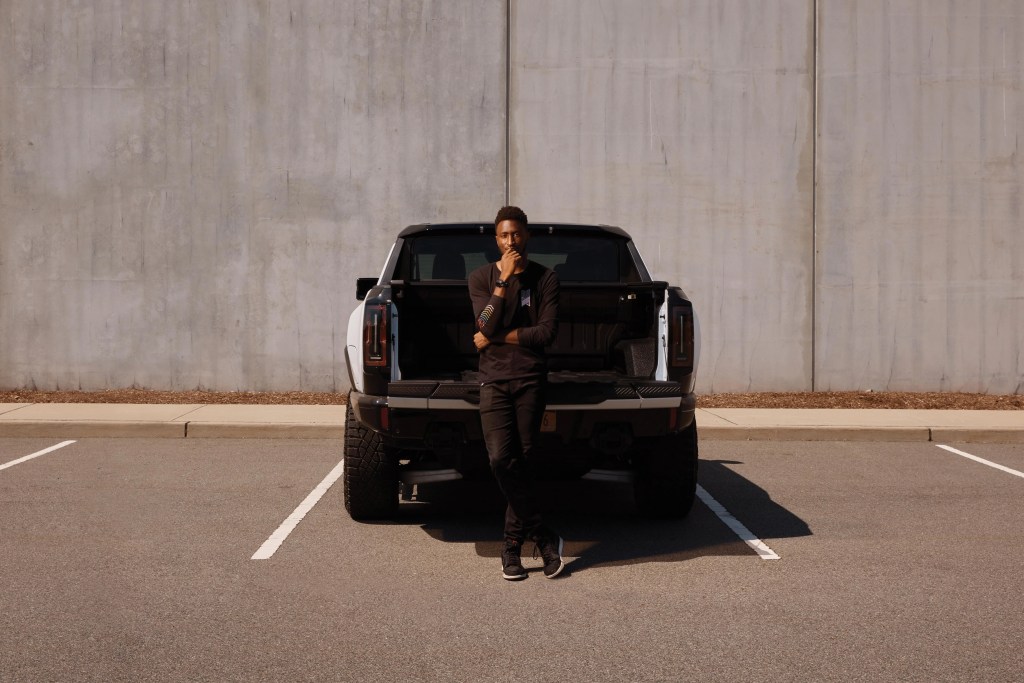 marques brownlee standing at the bed of a rivian truck