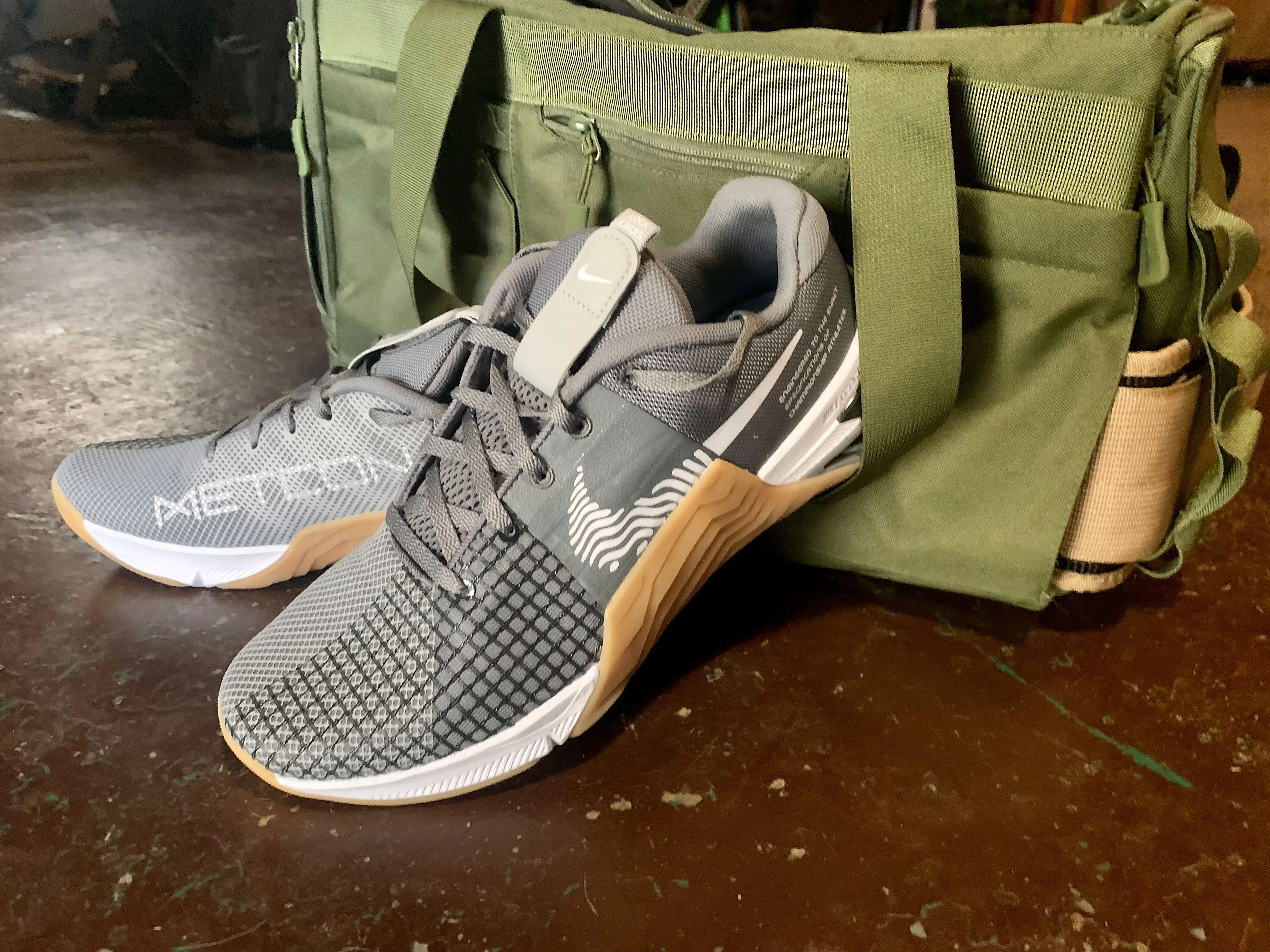 nike metcon 8 shoes next to a gym bag