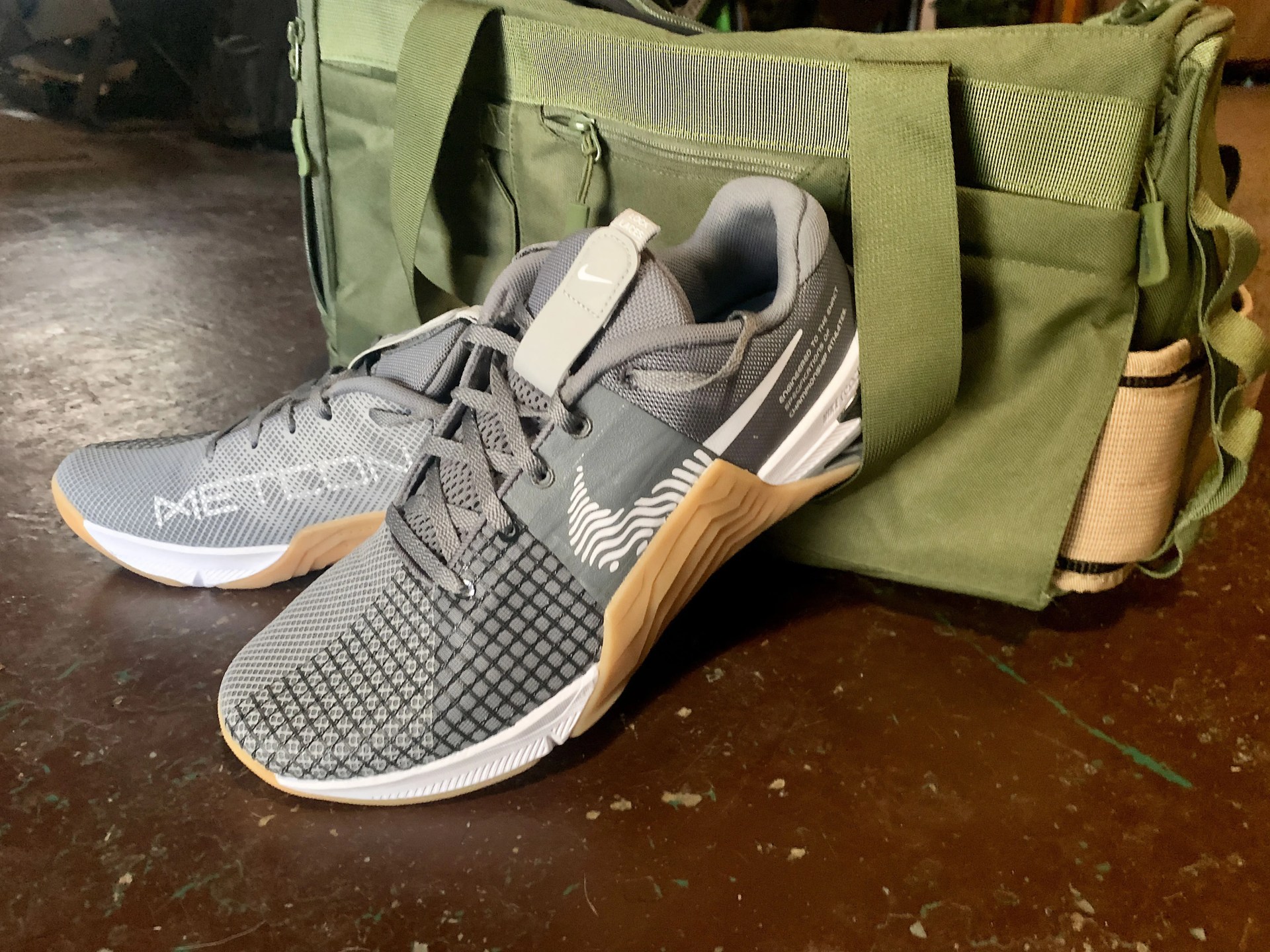 nike metcon 8 shoes next to a gym bag