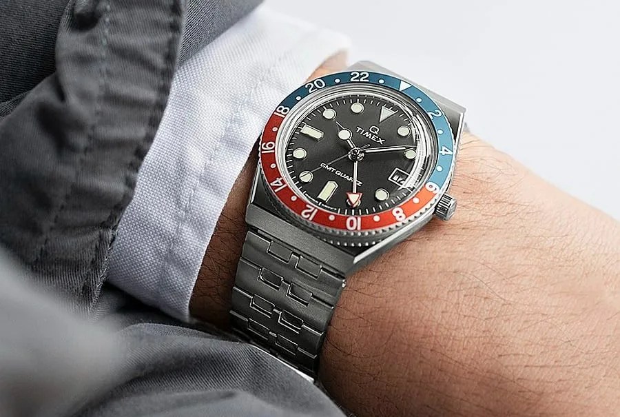 q timex gmt 38mm stainless steel watch on a wrist