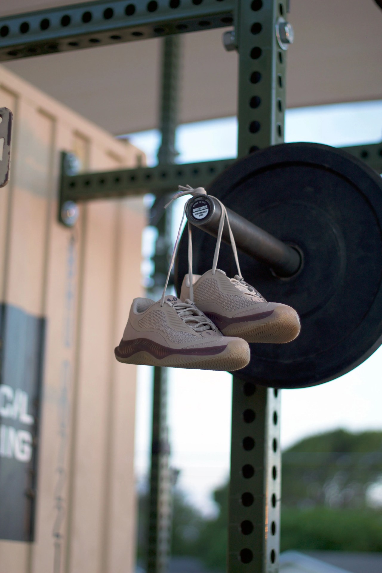 rad one shoes hanging from a benchpress