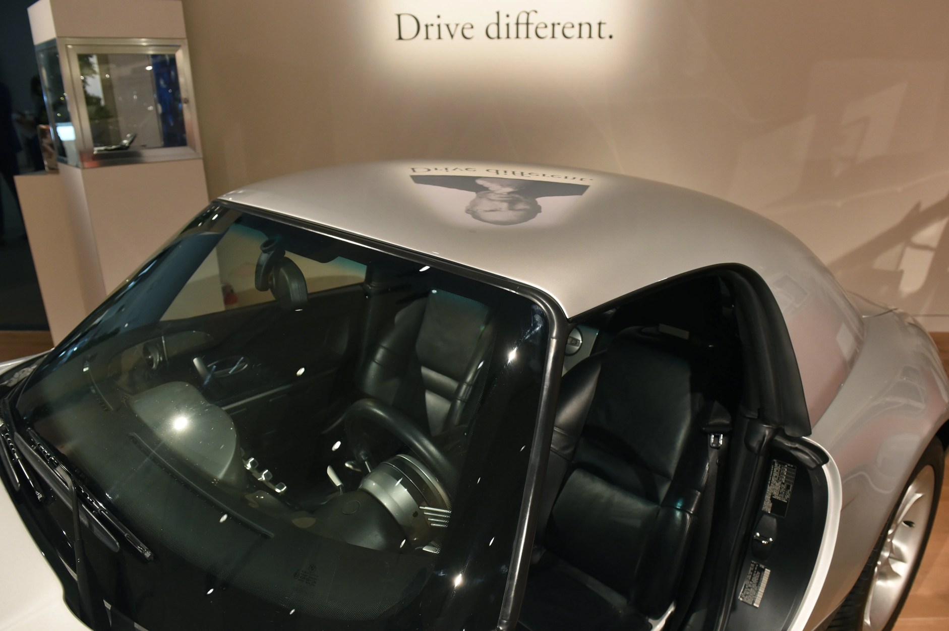 bmw z8 with projection of steve jobs on the roof