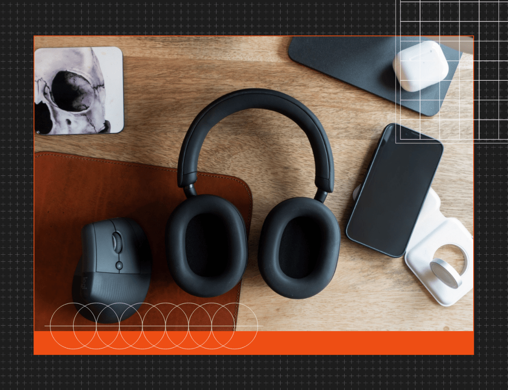 headphones and phone sitting on a desk