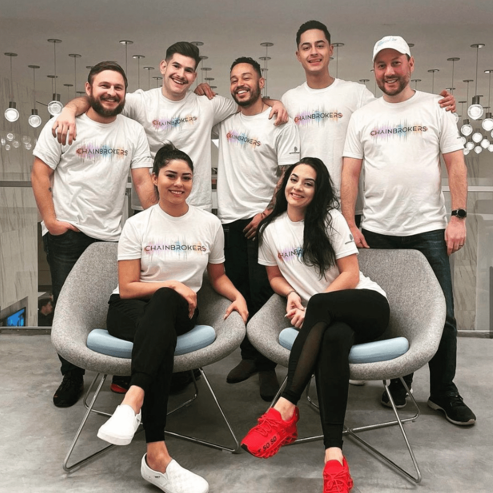 a group of people wearing a white shirt saying chain brokers printed by underground printing
