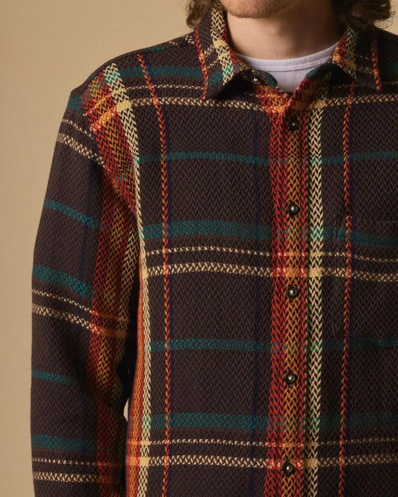 man wearing corridor acid plaid trailhead button up