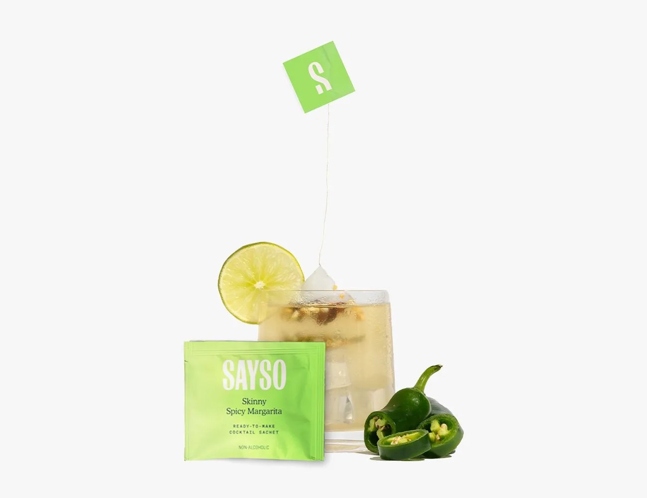 sayso skinny spicy margarita tea bag in a glass with a lime and jalapeños